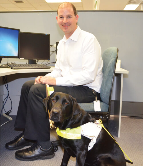 DMP employee Eric Seery with his guide dog Sundae.
