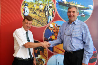 Petroleum Division Executive Director Jeff Haworth is congratulated by his predecessor Bill Tinapple