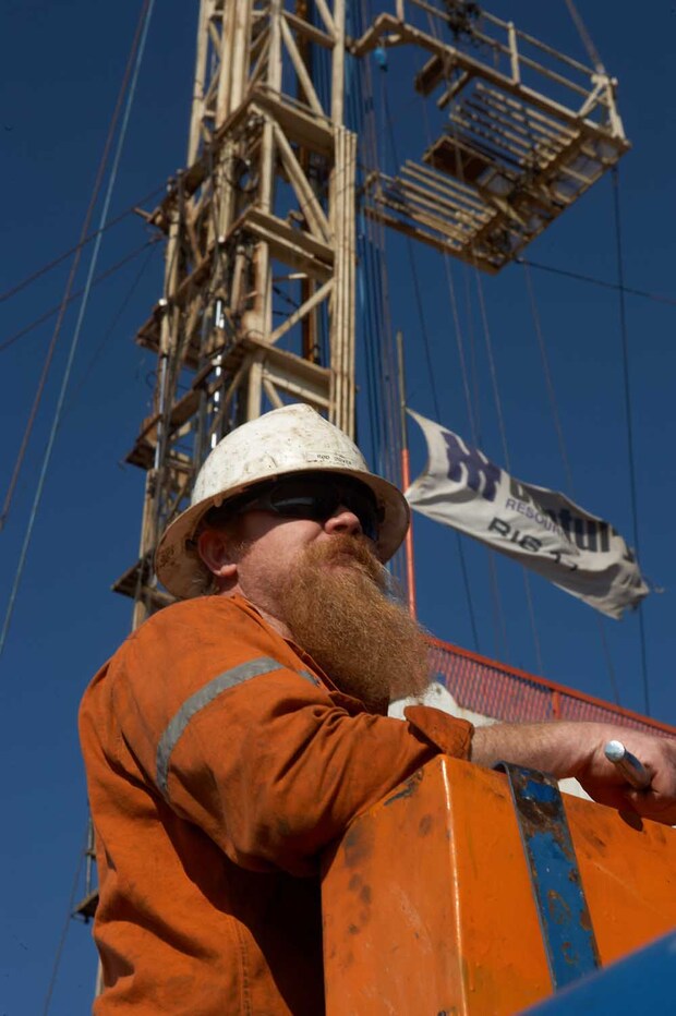 Roughneck standing in front of the derrick, onshore northern Perth Basin (courtesy ARC Energy Ltd)